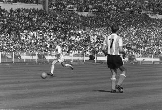 Argentina's Silvio Marzolini looks on as England's Nobby Stiles takes up possession at the 1966 World Cup.