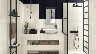 small ensuite with cream pearl ceramic tiles covering most of walls including built in vanity unit with shelvine, black shower screen, glass section in wall and black towel rail with shelves