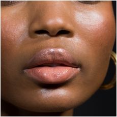 A model wearing colorful lashes and lip balm.