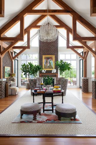 living room with high vaulted ceilings and low footstools