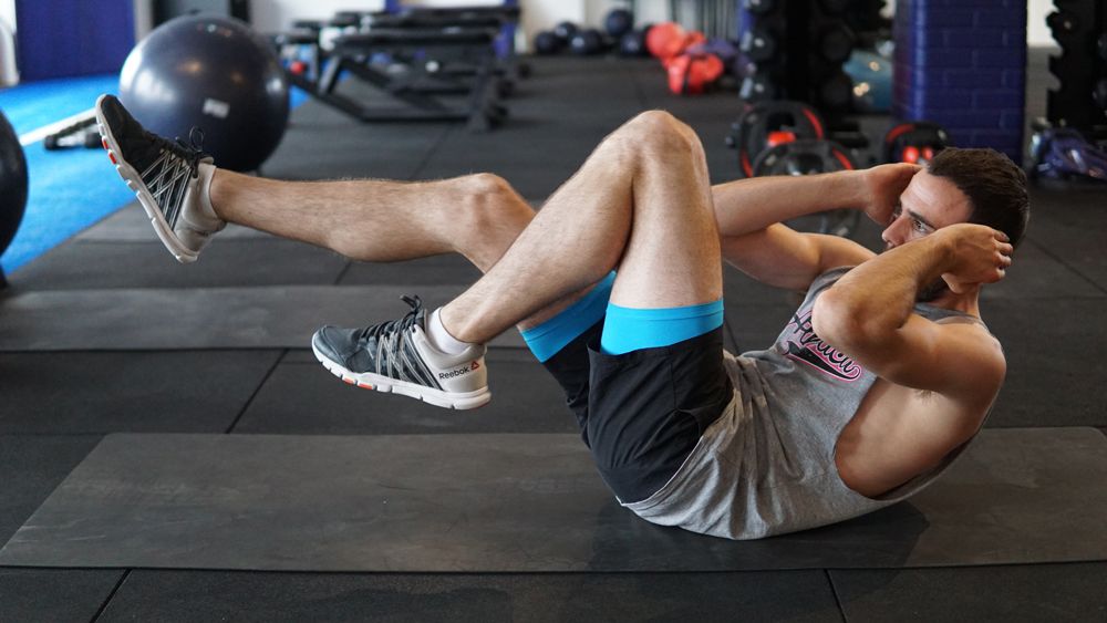 Man demonstrates bicycle crunch exercise