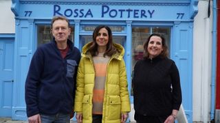 Julia outside Rossa's with the owner and his wife.