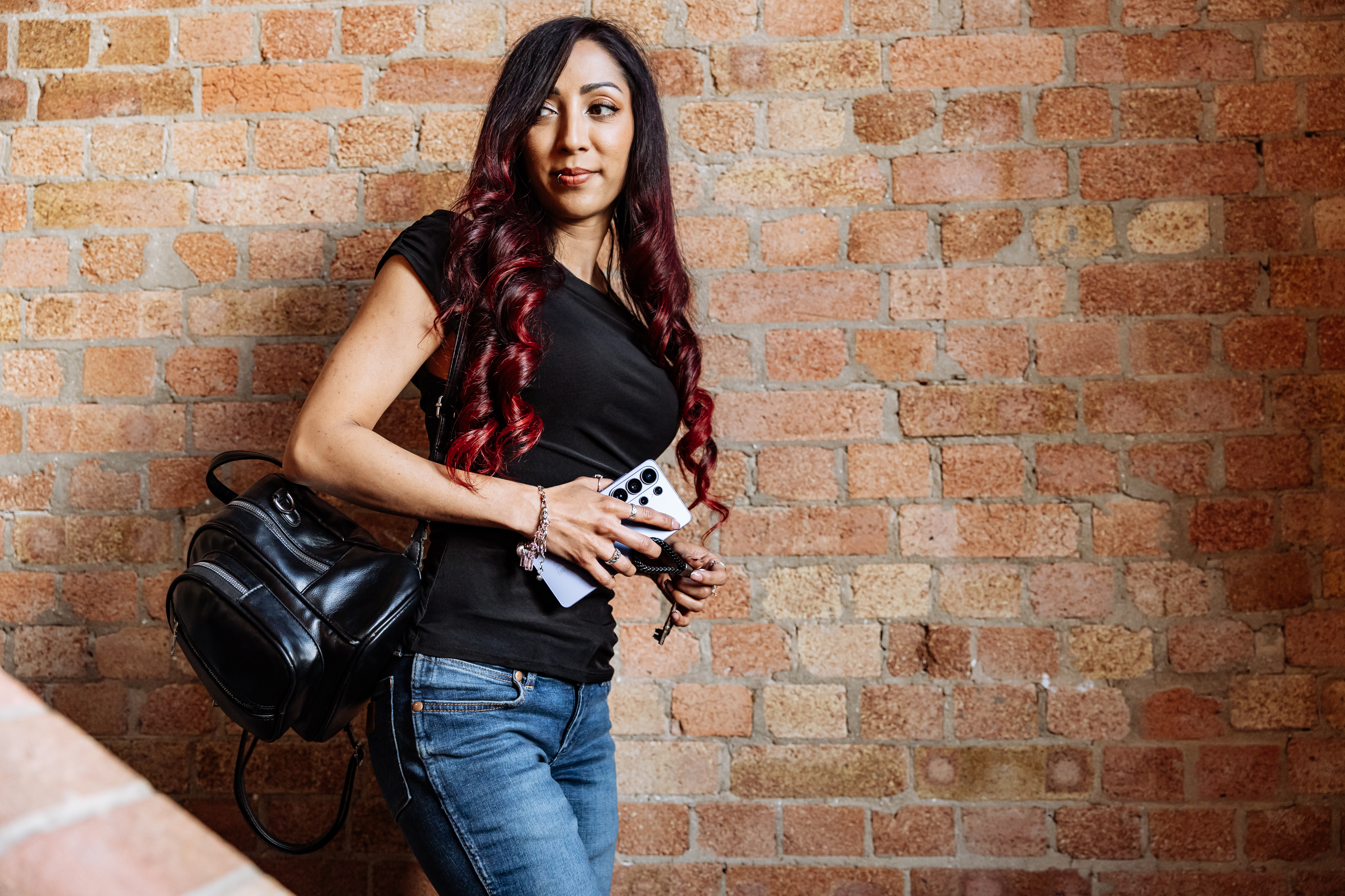 A woman holding a Samsung Galaxy S26 Ultra.