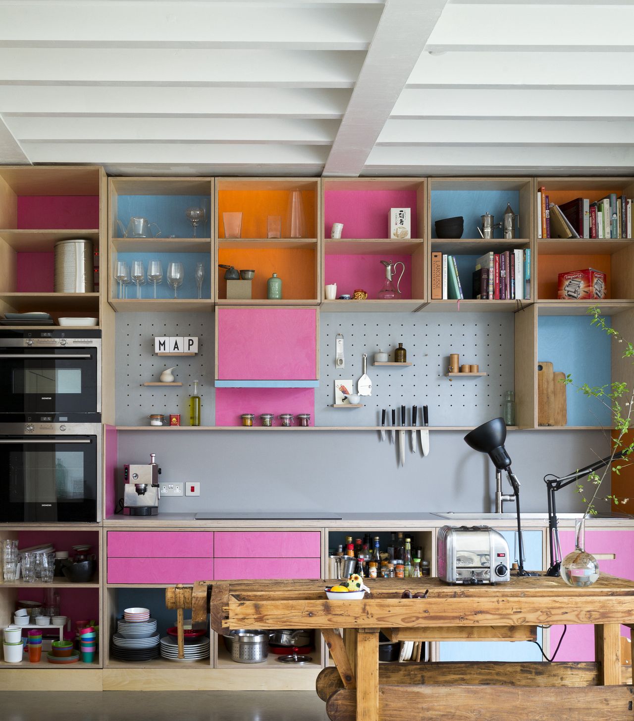 brightly painted open kitchen units