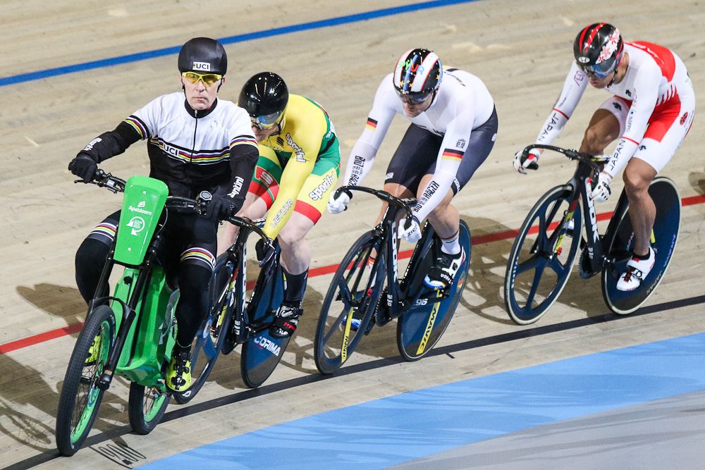 Lithuanian cyclist Vasilijus Lendel, Germany's Maximilian Levy and Japanese's Yuta Wakimoto compete in the first round of the men's Keirin