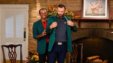 Tiger Woods hands Dustin Johnson his green jacket at the 2020 Masters