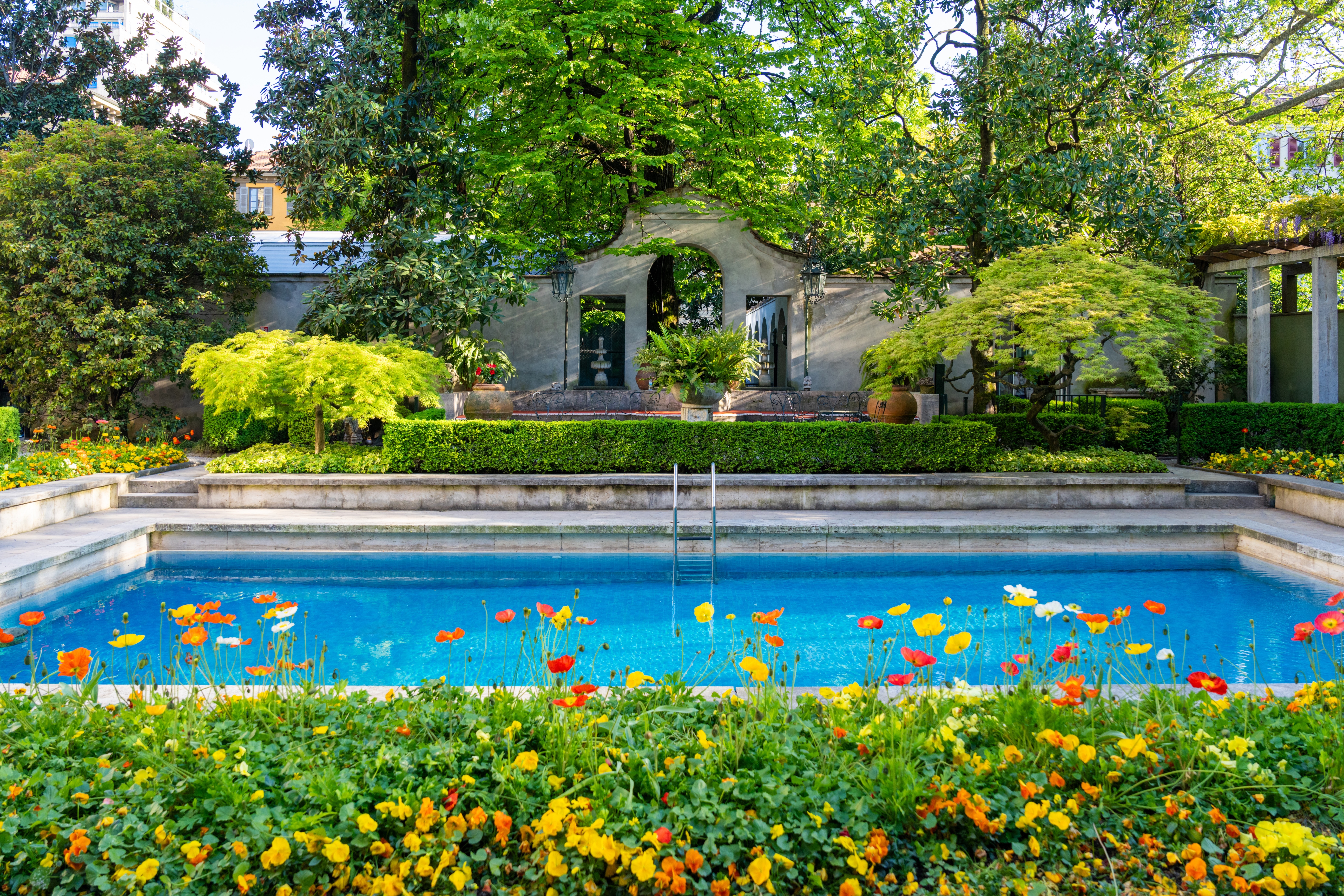Colourful flower bed framing a swimming pool