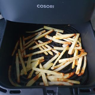 Chips in the open basket of COSORI Turbo Blaze air fryer