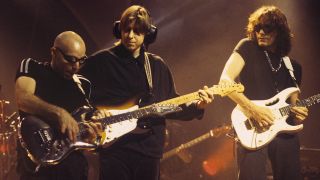 (from left) Joe Satriani, Eric Johnson and Steve Vai perform onstage