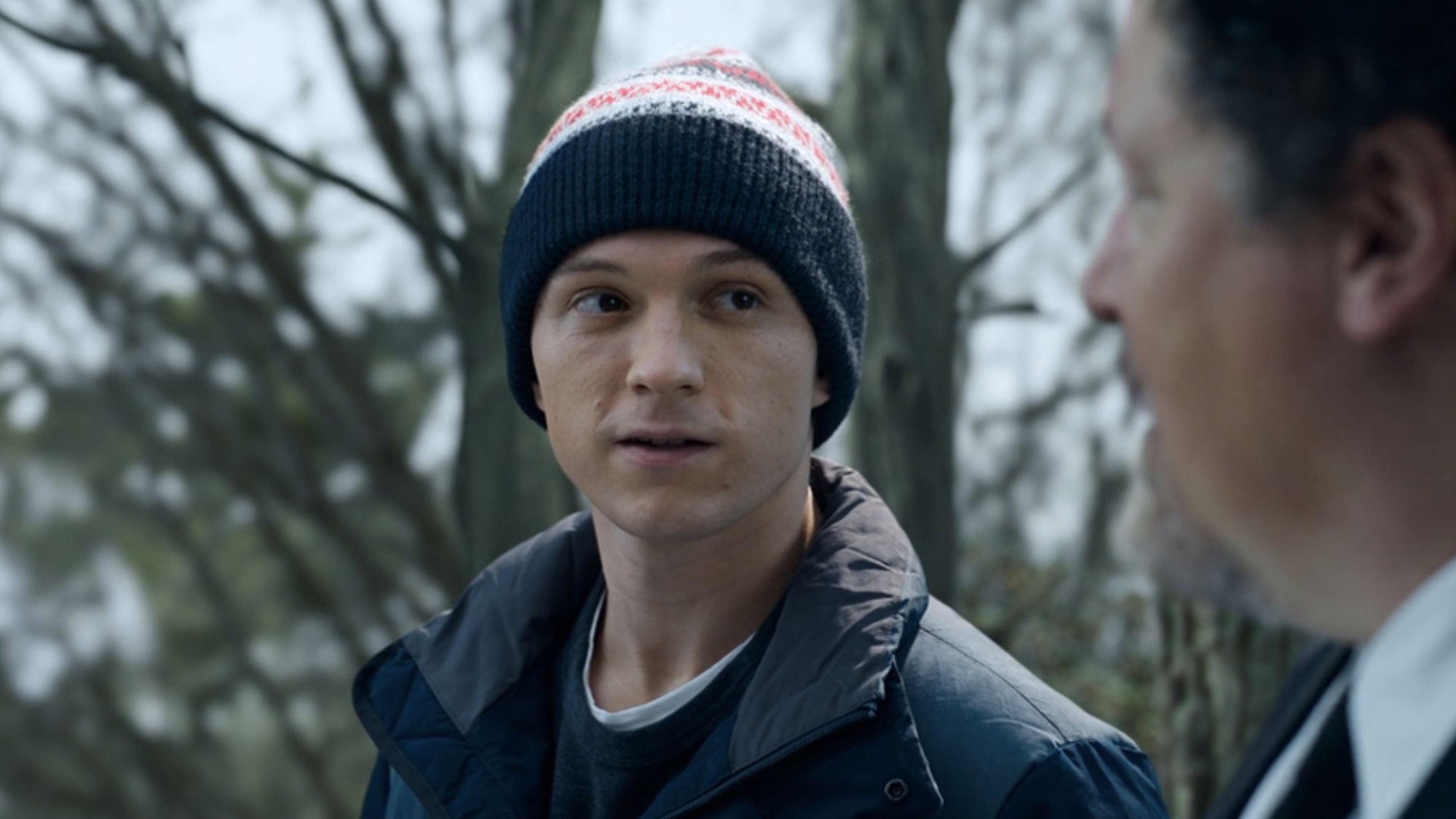 Peter wearing a hat talking to Happy at the end of No Way Home. 