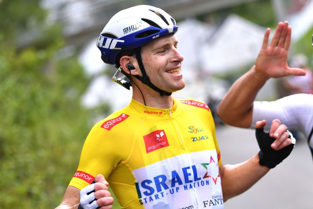 HARSTAD NORWAY AUGUST 08 Ben Hermans of Belgium and Team Israel StartUp Nation Yellow Leader Jersey celebrates at finish line with Teammates as race winner during the 8th Arctic Race Of Norway 2021 Stage 4 a 1635km stage from Gratangen to Harstad 54m ArcticRace on August 08 2021 in Harstad Norway Photo by Stuart FranklinGetty Images