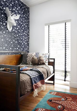 boys bedroom with industrial bed and patterned dark wallpaper