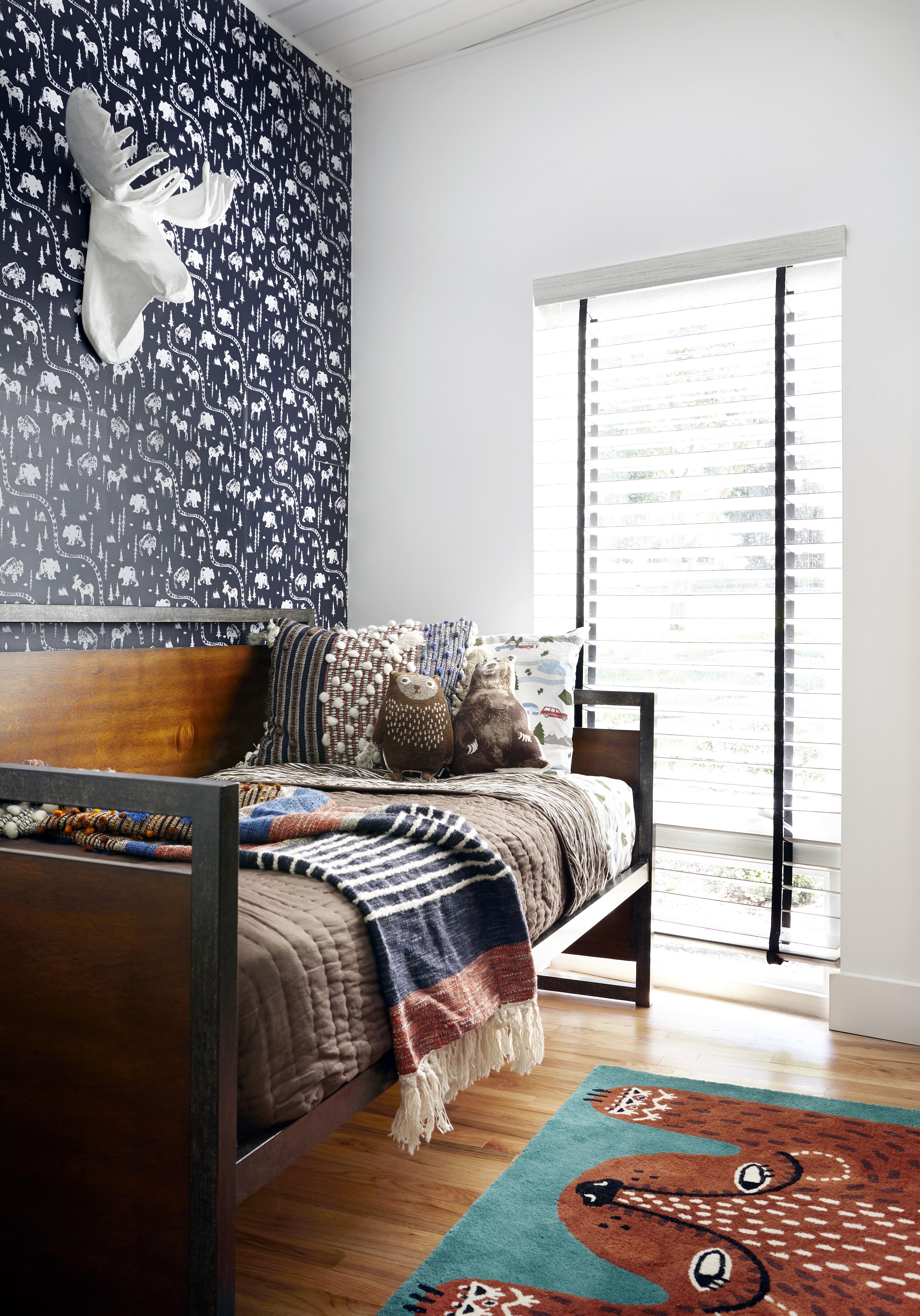 boys bedroom with industrial bed and patterned dark wallpaper