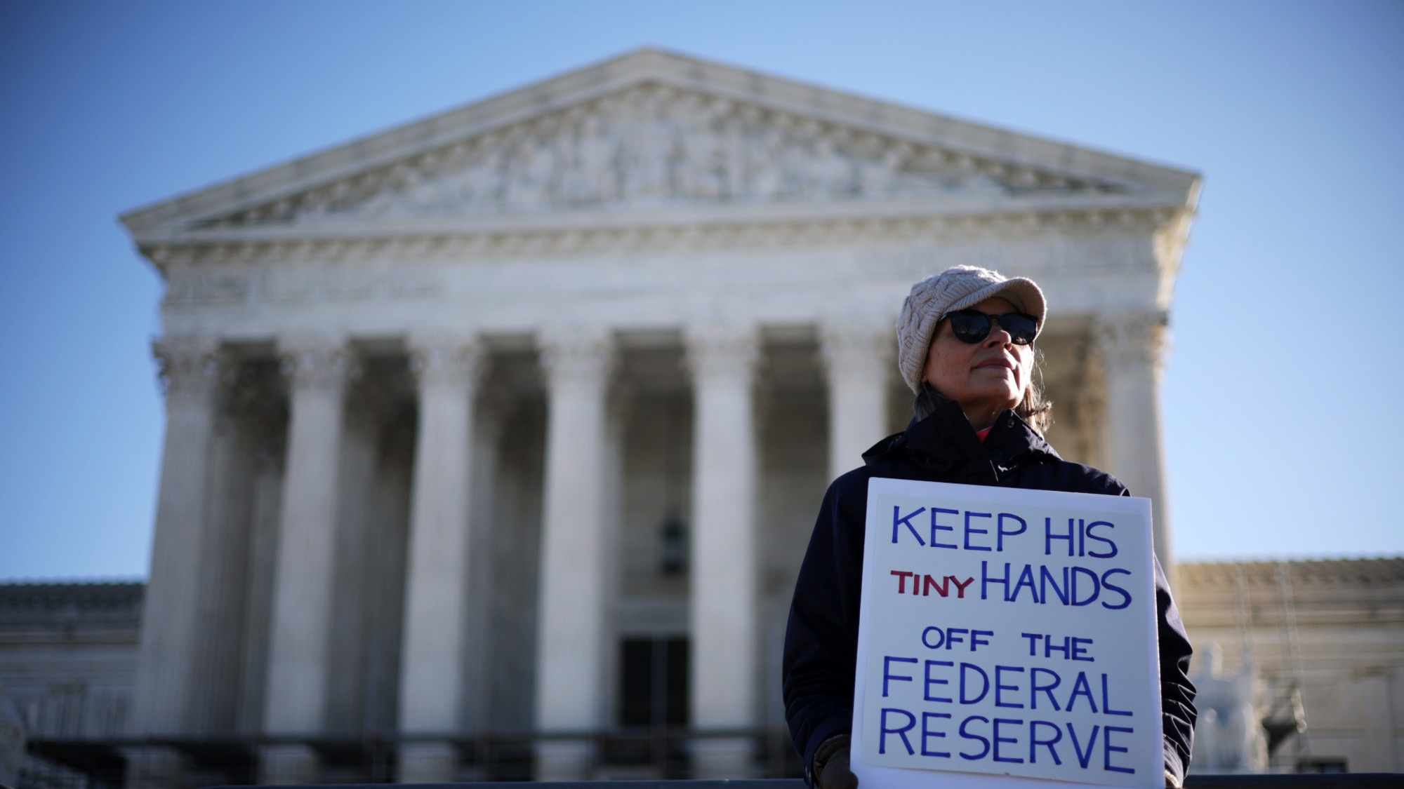 A woman holds a sign to support the Federal Reserve in front of the U.S. Supreme Court on January 21, 2026 in Washington, DC. The Supreme Court is hearing oral arguments in Trump v. Cook. 