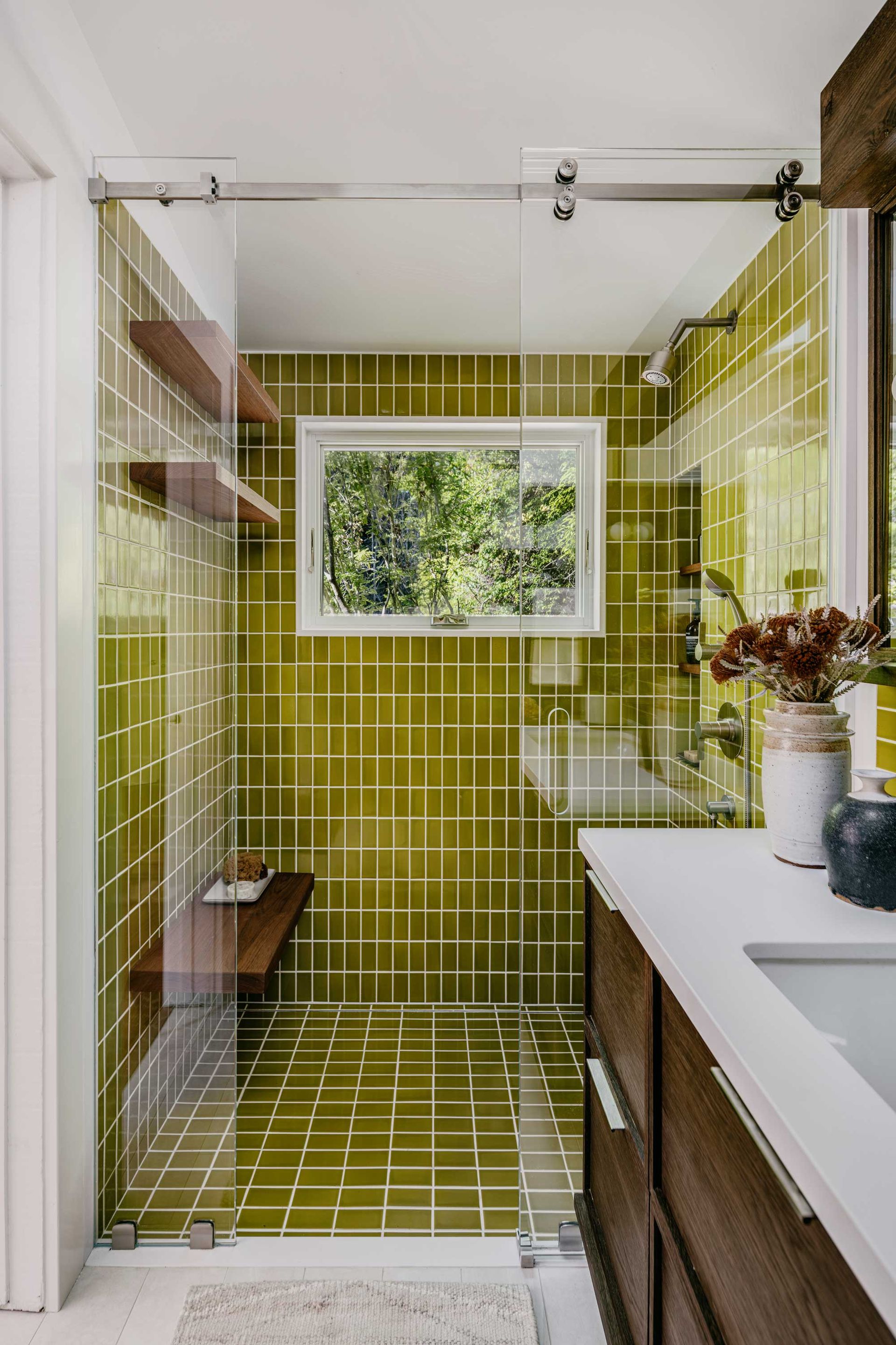 a bathroom with bright green tiles