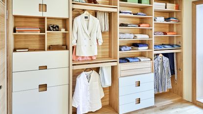 Open shelving an drawers plus hanging spae in woman&#039;s cream walk-in closet