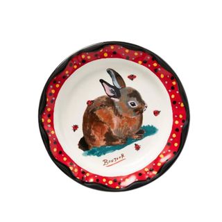 A red and white plate with a rabbit painting