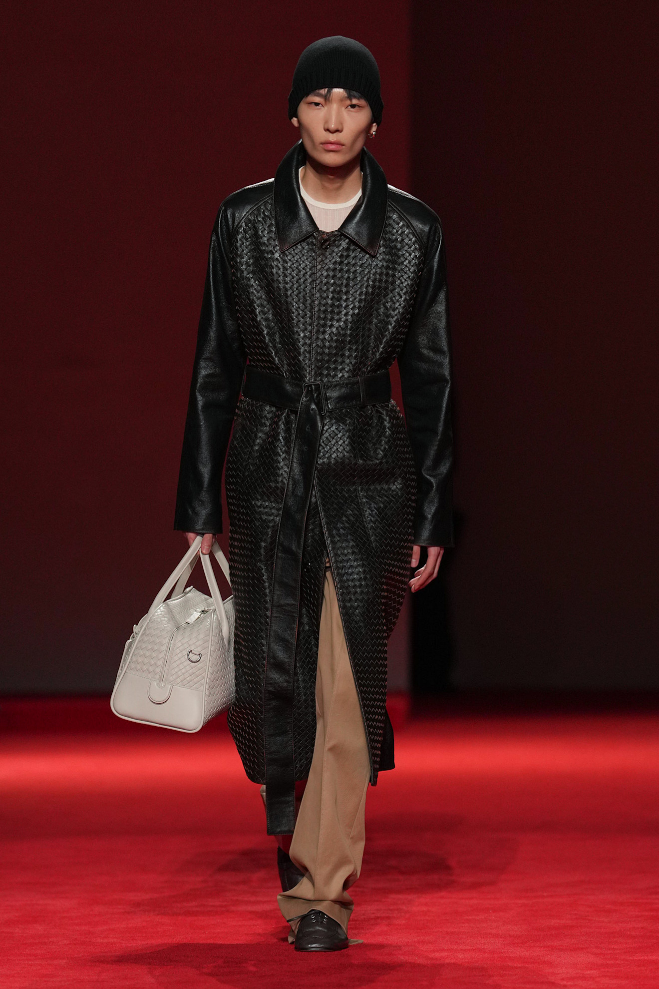 a Bottega Veneta model wearing a woven Bottega Veneta coat