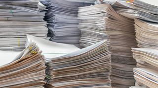 Stacks of paper on a desk in an office
