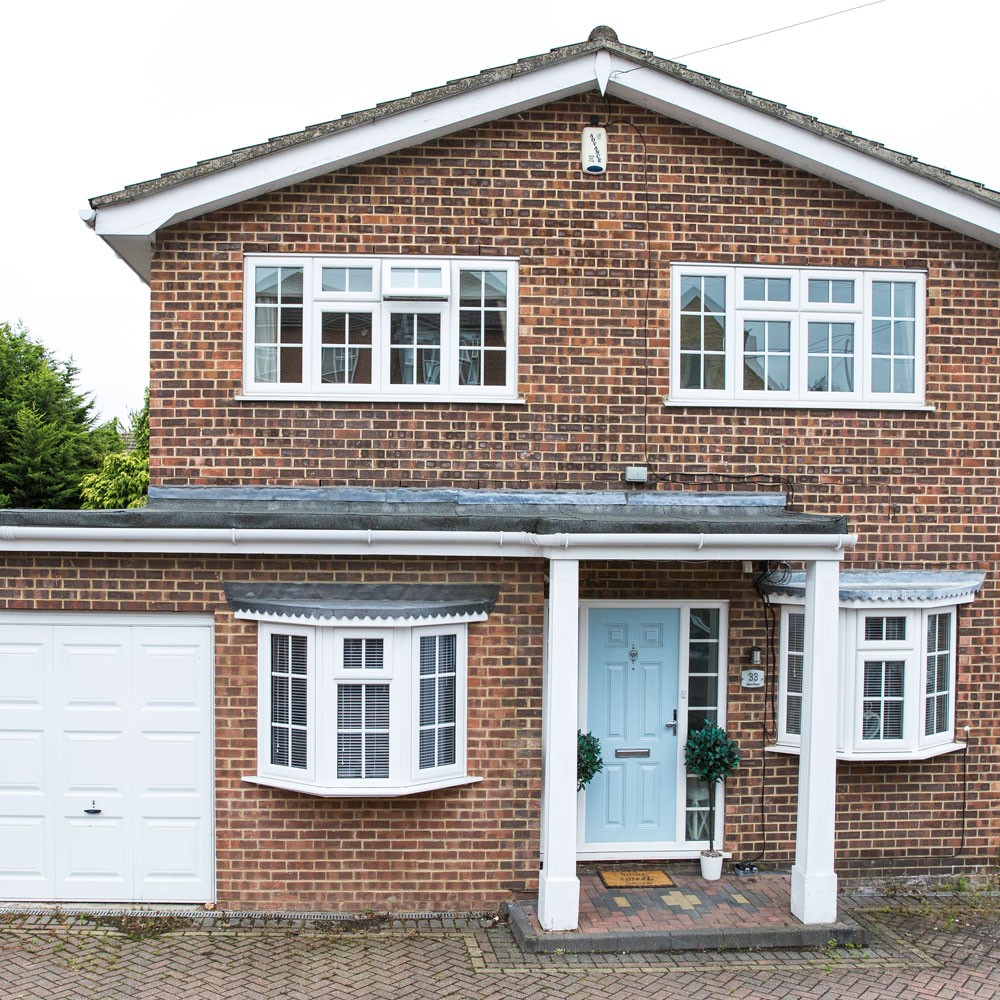house exterior with brick wall and white windows