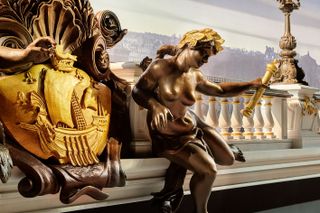 Close up view of brown and golden sculpture on railings