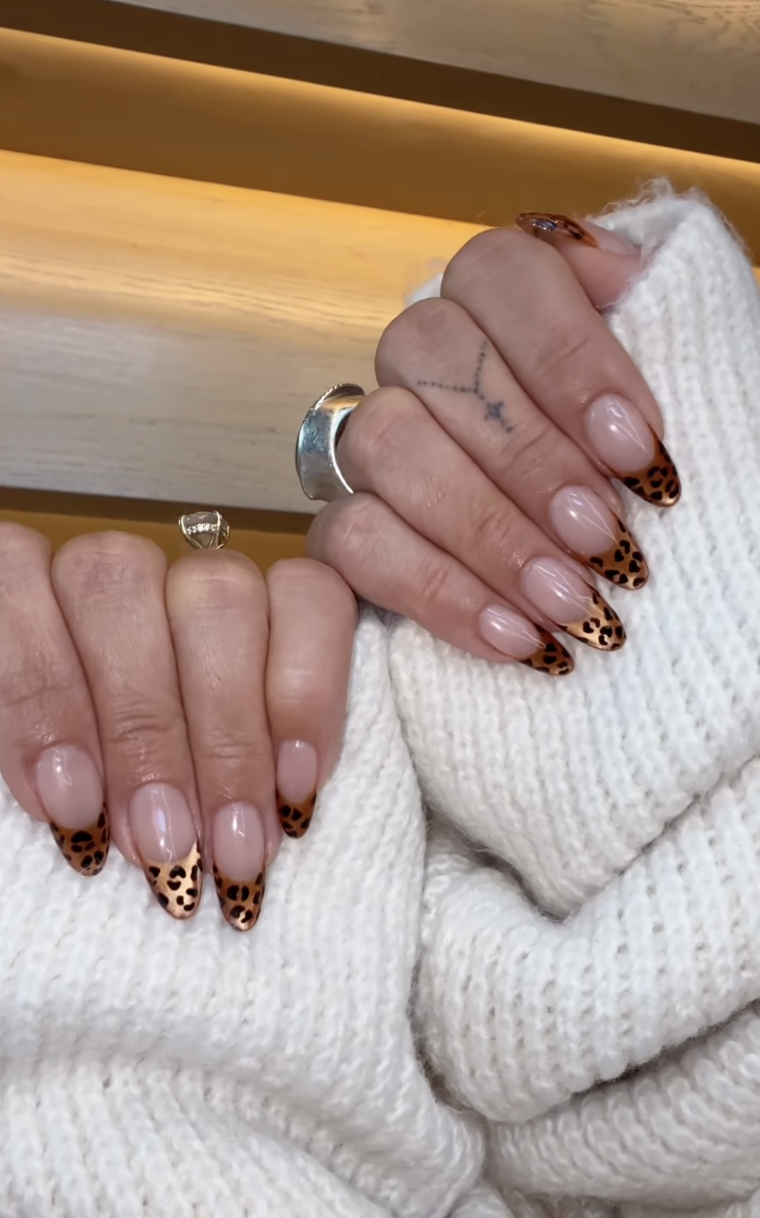 a person wearing velvet leopard nails