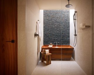 A bathroom with a bathtub and shower