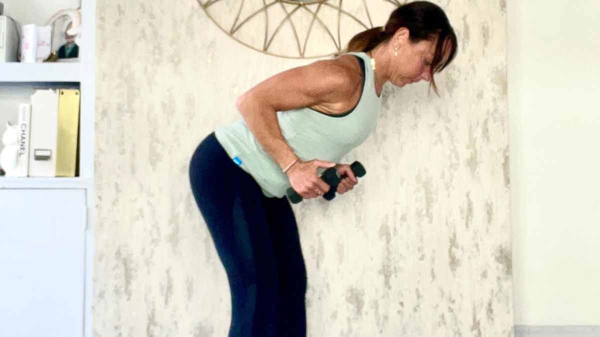 Lucy Miller performing triceps kickbacks at home during workout