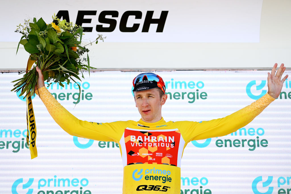 AESCH SWITZERLAND JUNE 13 Stephen Williams of United Kingdom and Team Bahrain Victorious celebrates winning the yellow leader jersey on the podium ceremony after the 85th Tour de Suisse 2022 Stage 2 a 198km stage from Kusnacht to Aesch ourdesuisse2022 WorldTour on June 13 2022 in Aesch Switzerland Photo by Tim de WaeleGetty Images