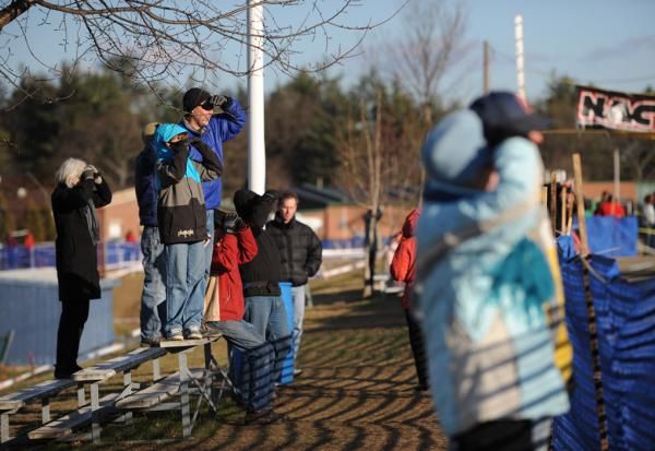 Spectators watch the racers on the far side of the course.