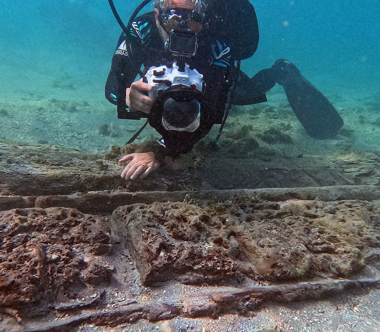 A close up of several shipwreck fragments at the bottom of the seafloor.