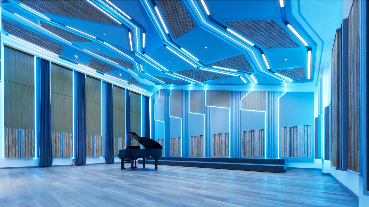 Ascentone Studios, a Beijing recording studio, by WSDG, showing piano in blue-lit space