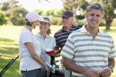 Two couples golfing.