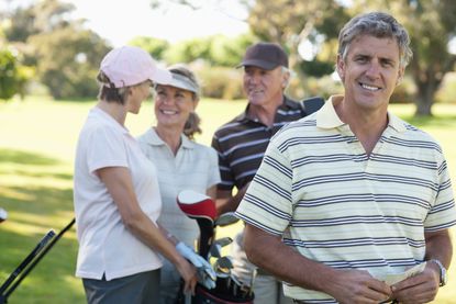 Two couples golfing.