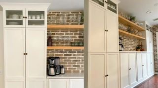 Cream cabinets surrounding a bare brick wall in a kitchen pantry