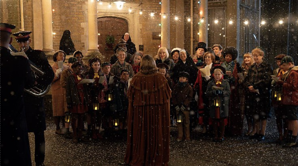 The residents of Poplar gather to sing carols in a scene of the Call the Midwife Christmas special