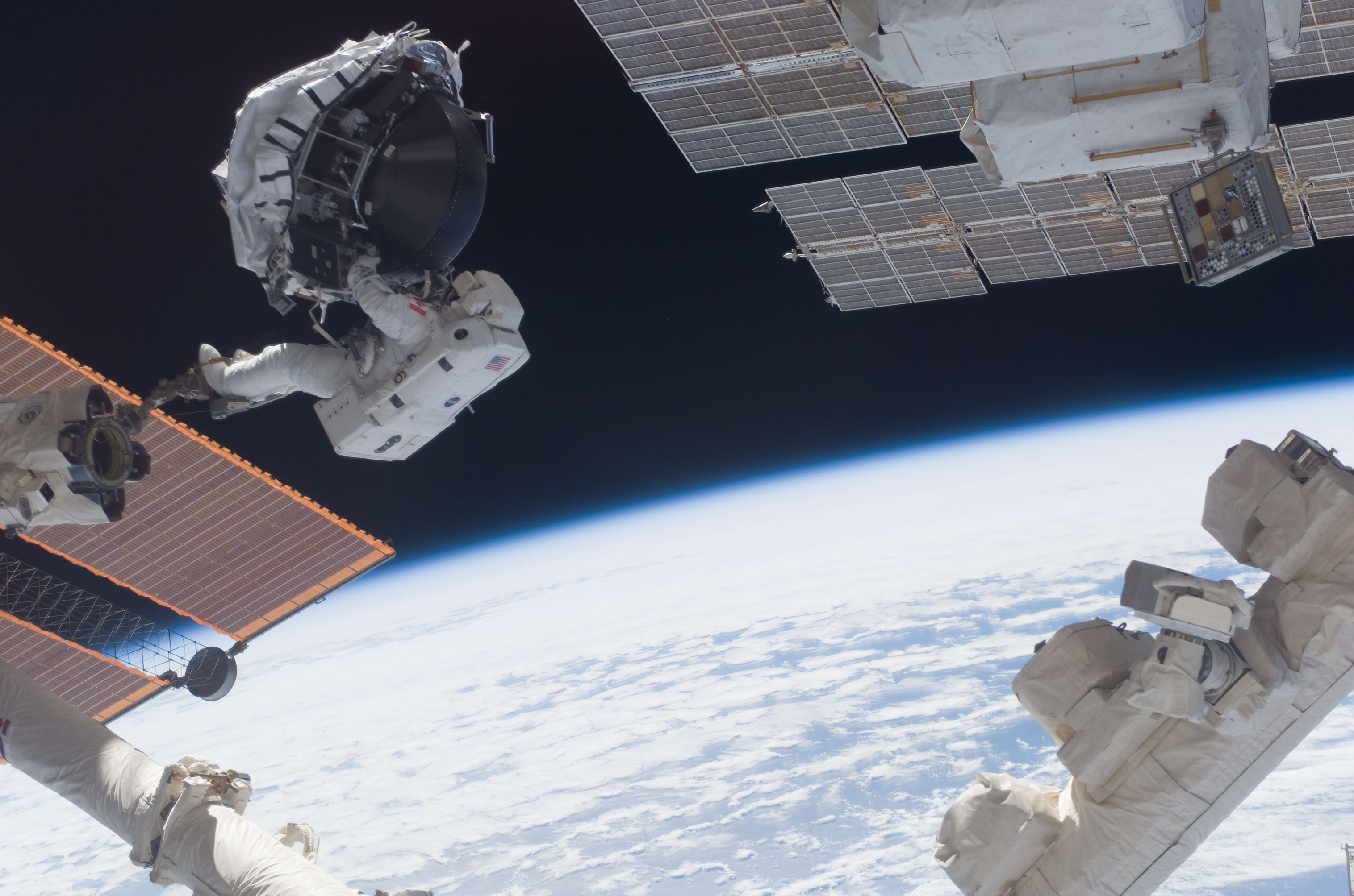 STS-118 Canadian Space Agency Astronaut and Mission Specialist (MS), Dafydd Williams, attached to an Adjustable Portable Foot Restraint (APFR) on the end of the Space Station Remote Manipulator System (SSRMS)/Canadarm 2 as it transports the new Control Moment Gyroscope (CMG) to the External Stowage Platform 2 (ESP2) for temporary stowage.