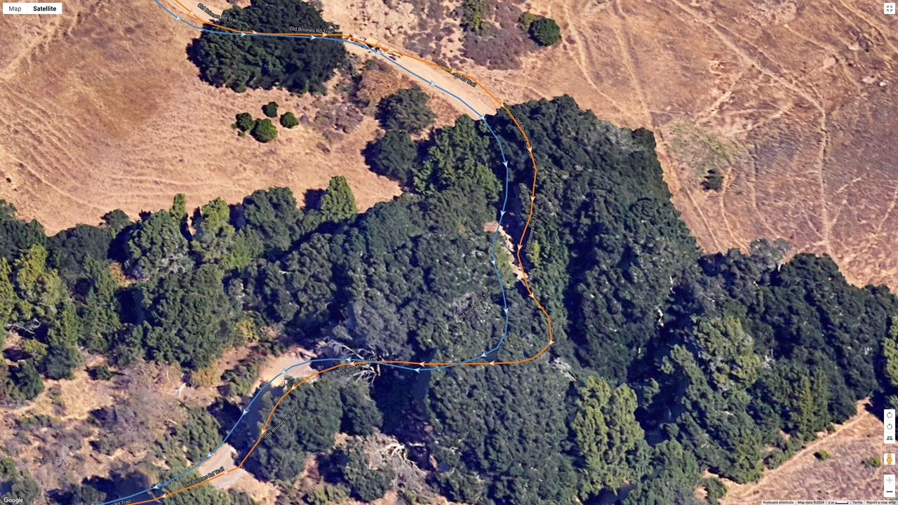 A Google Earth satellite image showing how the COROS PACE Pro (blue line) compares to the Garmin Fenix 8 (orange line) for a dual-band GPS accuracy test.