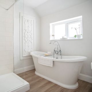 bathroom with white bath tub and white wall