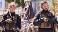 (L-R): Arielle Kebbel as Belle Skinner and Logan Marshall-Green as Pete Calvin holding guns.