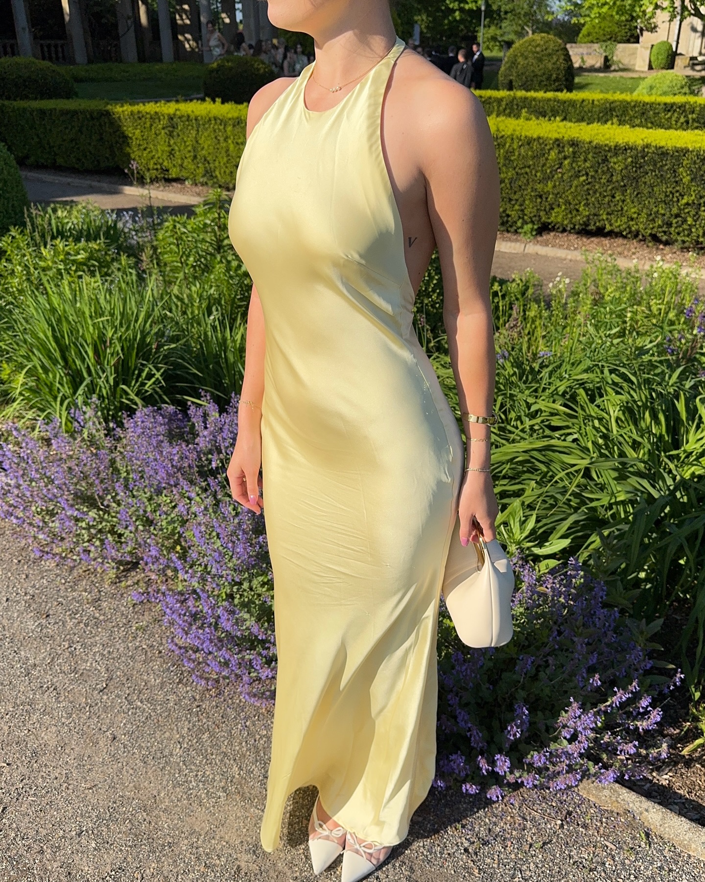 @maggie_mccormack wears a yellow satin dress to a summer wedding