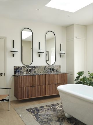 A bathroom with marble flooring under the bath