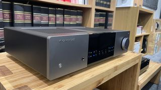 Cambridge Audio EXA100 integrated amplifier on hi-fi rack in front of case