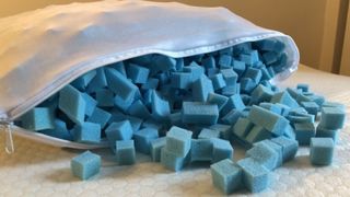 The Simba Hybrid Pillow unzipped to reveal removable blue foam filling.