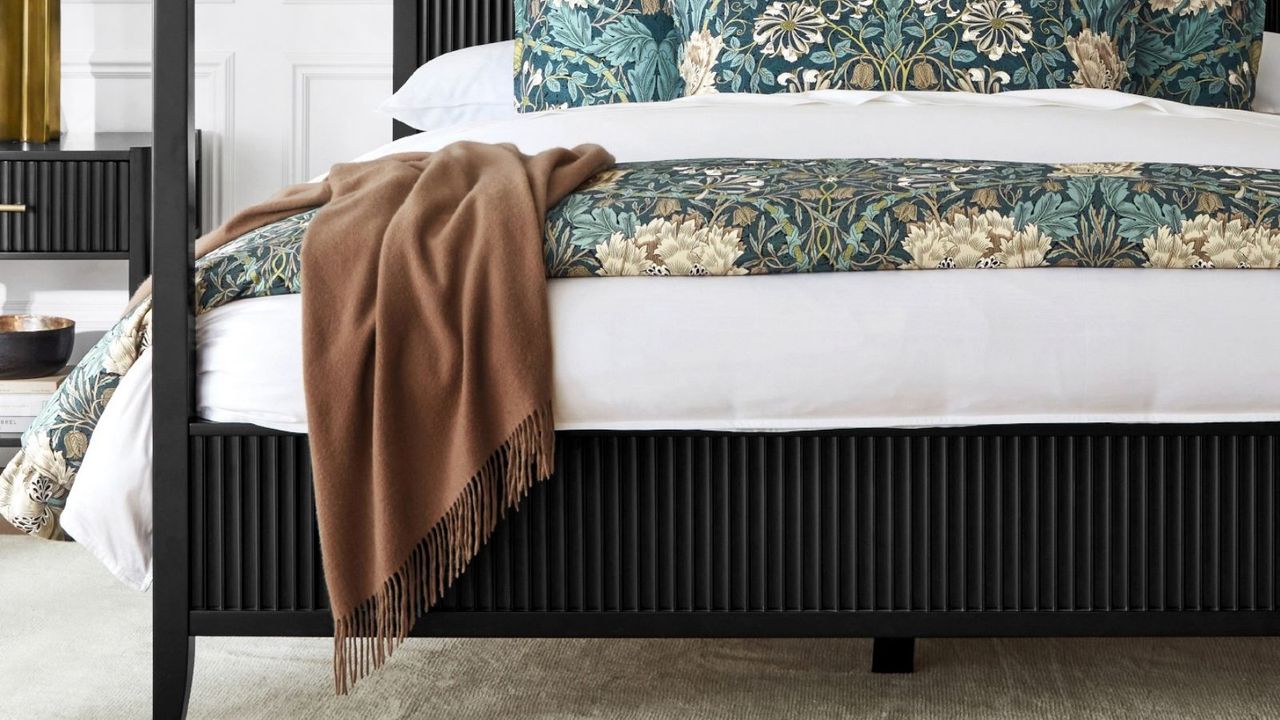 A European Solid Cashmere Throw draped over a bed