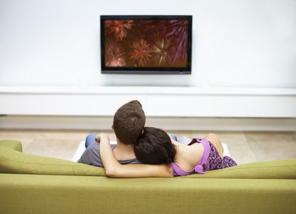 Young couple watching television