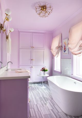 A bathroom drenched in soft pink paint