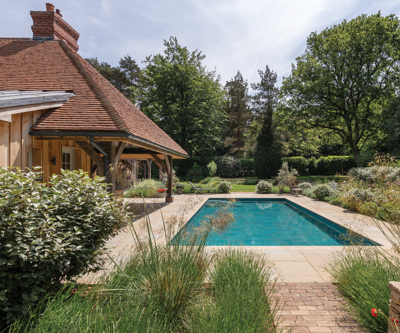 pool in garden with house on left hand side