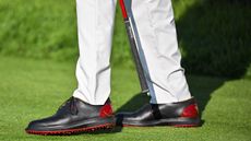 Close-up of Tiger Woods wearing Sun Day Red shoes at Riviera Country Club ahead of the 2024 Genesis Invitational 