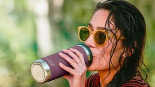 Woman drinking from a YETI Rambler bottle